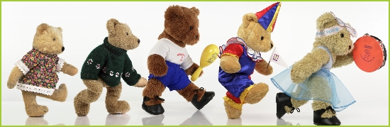 Photo of Melody Bear leading five bear friends in a musical parade