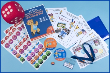 Photo of the First Tap & Modern reception age syllabus package with a file, big dice, CDs and dance teacher resources