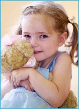 Photo of girl dancer age 3 hugging Melody Bear
