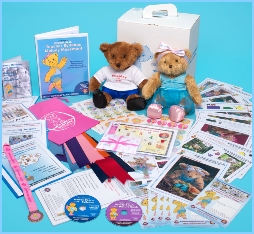Melody Bear sits with the box that contains her teaching syllabus