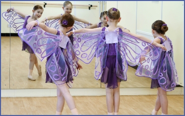 Photo of three girs dancing as butterflies