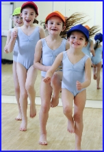 Photo of three girls in baseball caps running to keep fit and healthy