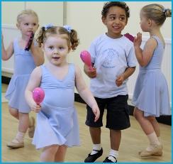 Girls and boys dancing with musical instruments