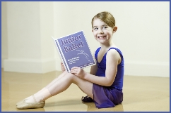 Photo of a Junior Ballet dancers holding her work file