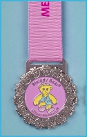 Photo of First Tap & Modern with Melody Bear badges on a lanyard