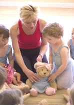 Young dancers help dress dancing teddy, Melody Bear, in Jill Bridger's pre-school lessons