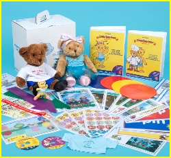 Melody Bear sits with the box that contains her teaching syllabus copyright M Ewing J Ewing Melody Movement Early Learning