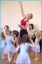 Photo of nursery aged children doing an apple picking dance