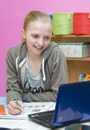 A young dancer doing her homework
