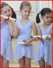 Girls receiving their Foundation Ballet Graduation certificates
