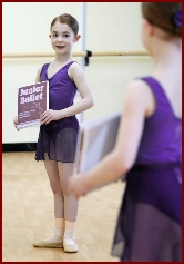 Jewel Ballet dancer looks at herself in a mirror