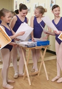 Dancing friends collect their work